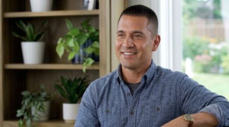 Smiling Man with Crew Cut in Casual Blue Shirt at Home