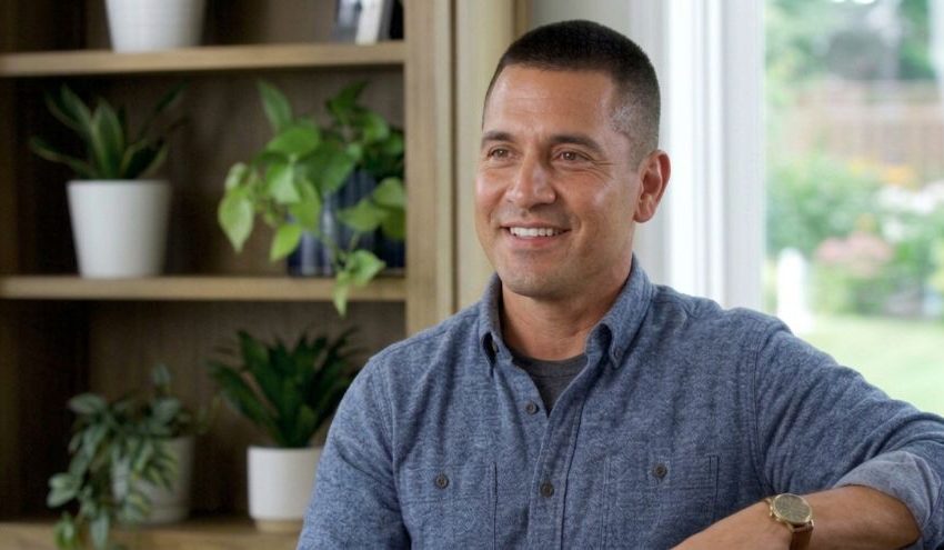 Smiling Man with Crew Cut in Casual Blue Shirt at Home